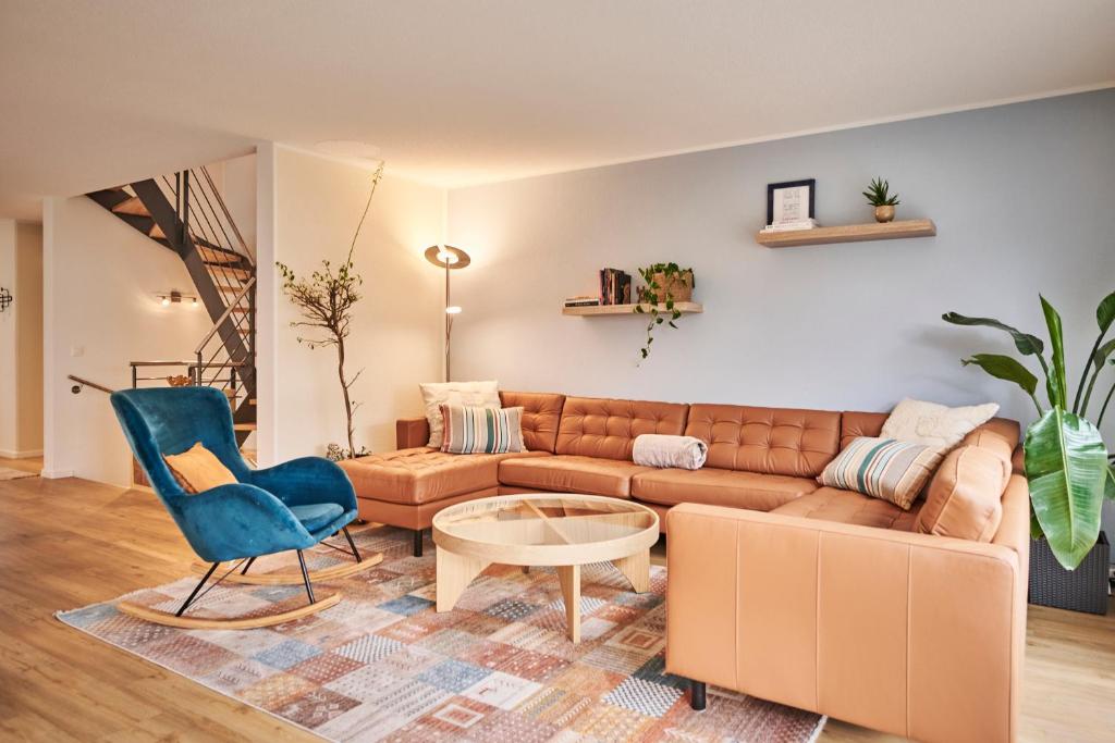 a living room with a couch and a table at Chalet in Thun, modern, spacious, perfect location in Thun