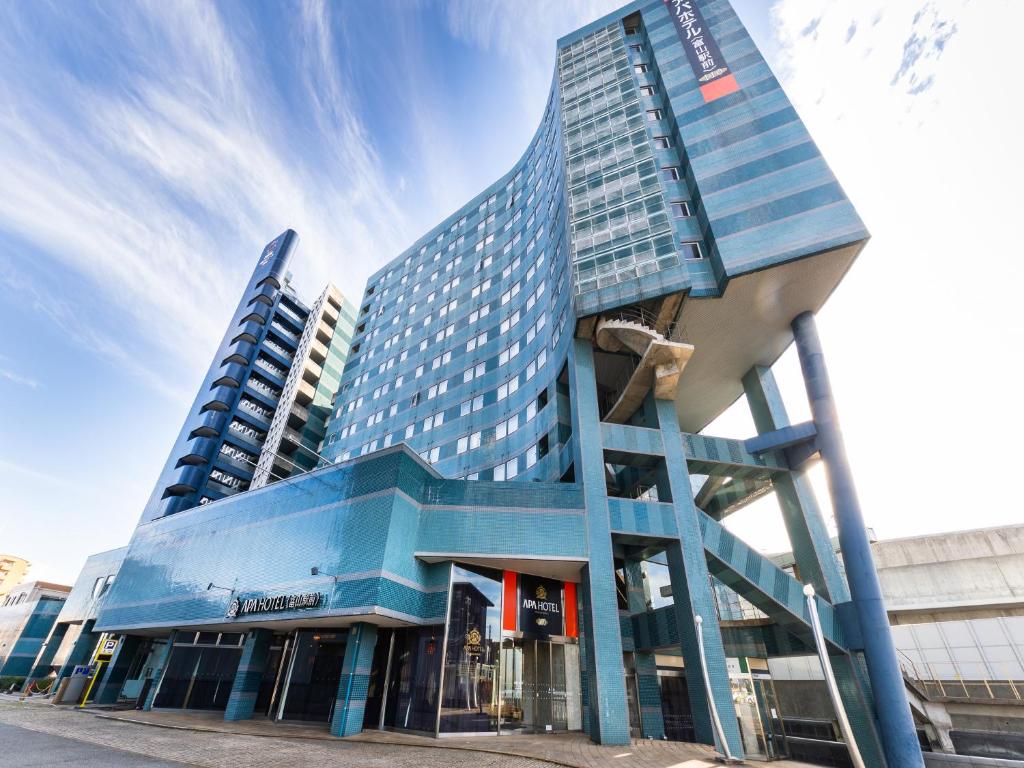 a tall blue building with a blue at APA Hotel Toyama Ekimae in Toyama