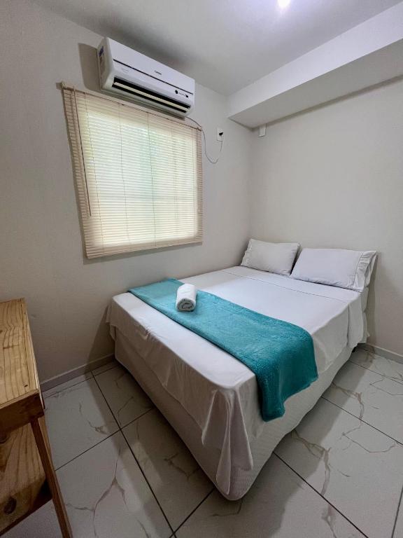 a bedroom with a bed with a air conditioner at Suíte Peroba em Maragogi in Maragogi