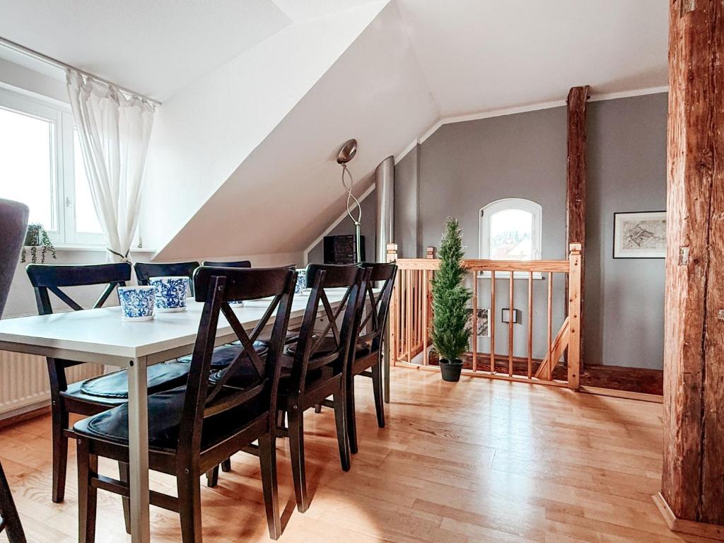 a dining room with a table and chairs at Sky Maisonette Pirna Altstadt mit 2 Schlafzimmer und extra großem Wohn-Essbereich in Pirna