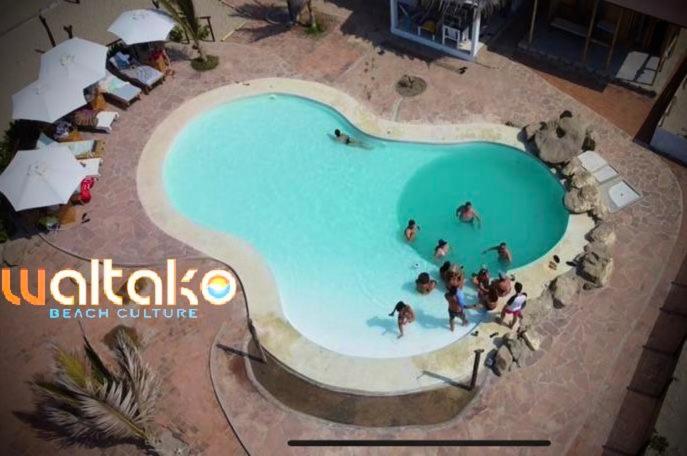a large swimming pool with people in the water at Casa Waltako in Canoas