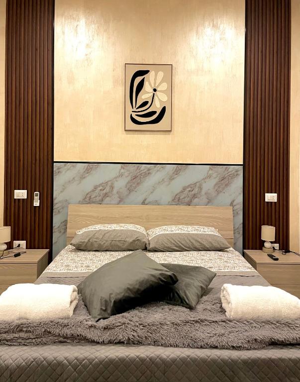 a bedroom with a large bed with a large headboard at Dimora Borbonica 1 in Marcianise