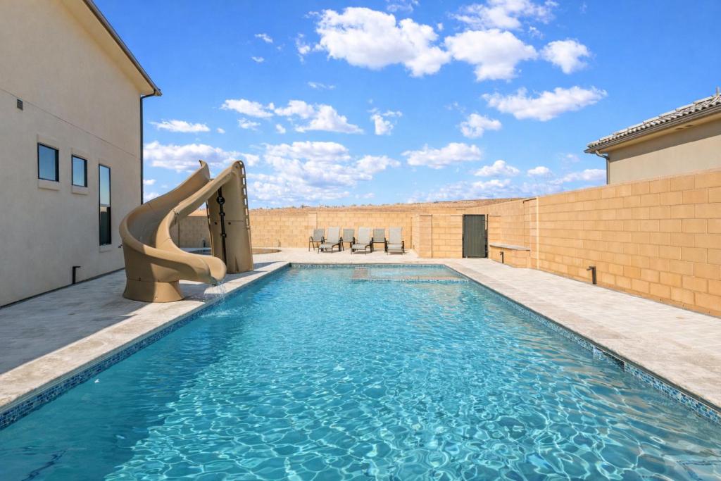 a swimming pool with a slide in a building at Splash and Putt Paradise home in Washington