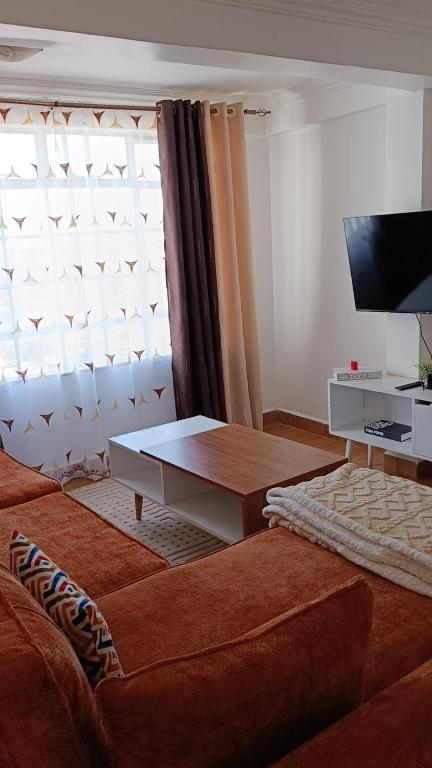 a living room with a couch and a coffee table at Cosmic home in Thika