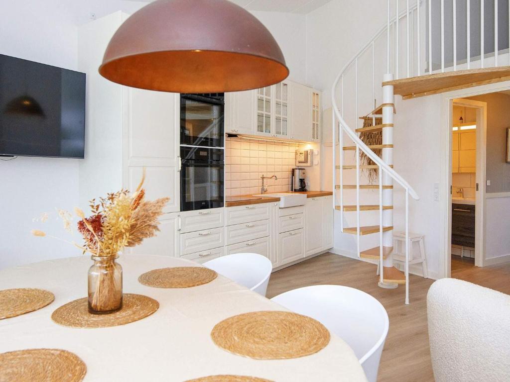 a kitchen and dining room with a table and chairs at 8 person holiday home in Ringkøbing-By Traum in Ringkøbing