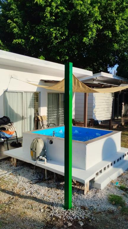 a white boat with a canopy in a yard at Casa iguana in Potrero