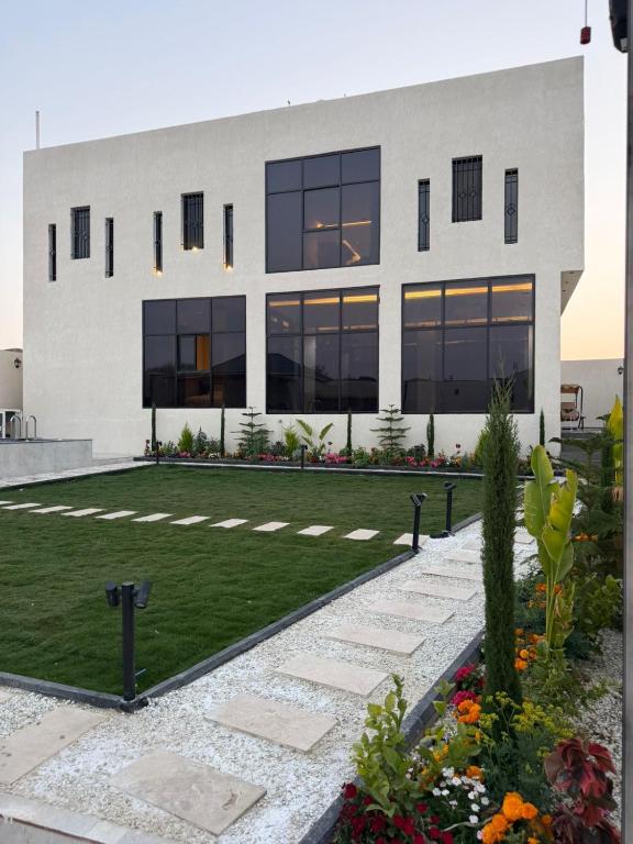 a large building with a lawn in front of it at فيلا شاليه ذا ويسس in Taif