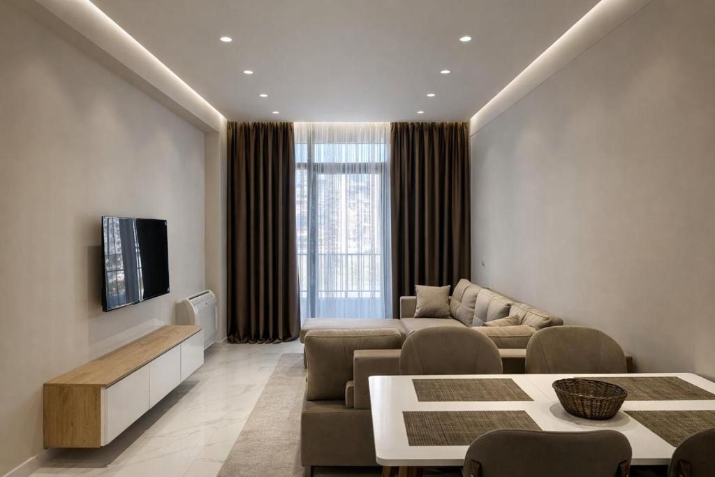 a living room with a couch and a table at Adan Luxury Aparthotel in Orikum
