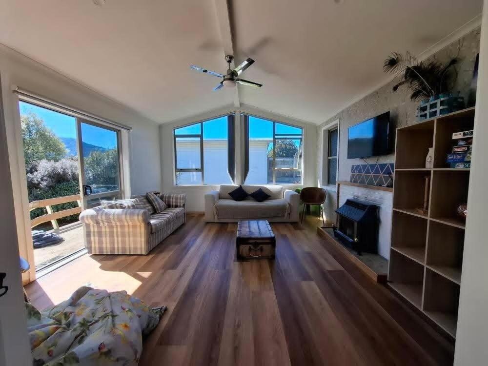 a living room with a couch and a table at All decked out in Rotorua