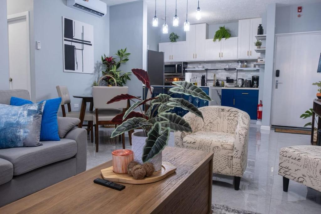 a living room with a table with a plant on it at East Lake Oasis in Arima