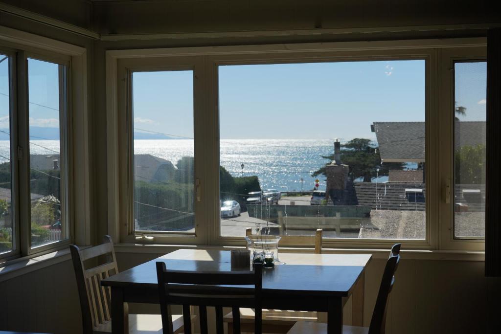 a dining room table with a view of the water at East Side Beach House in Santa Cruz