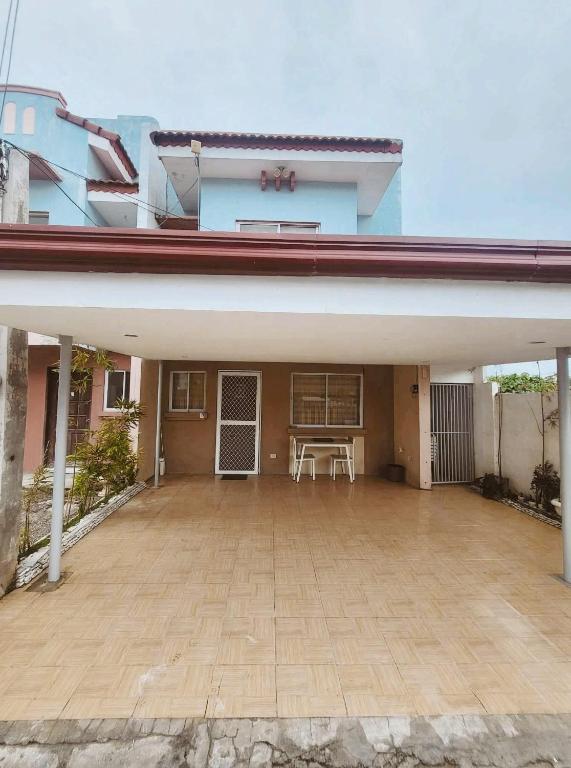 a building with a large patio in front of it at Abode86-PGT Townhouse2 in Lapu Lapu City