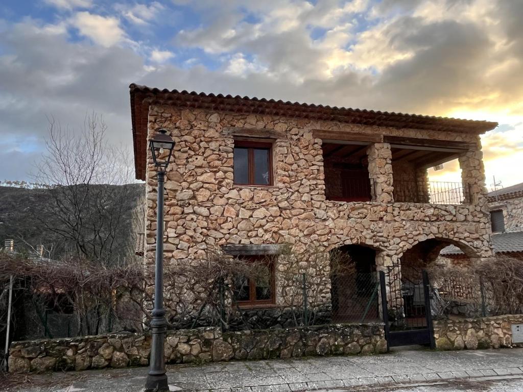 a stone building with a street light in front of it at Refugio del Mundo in Riópar