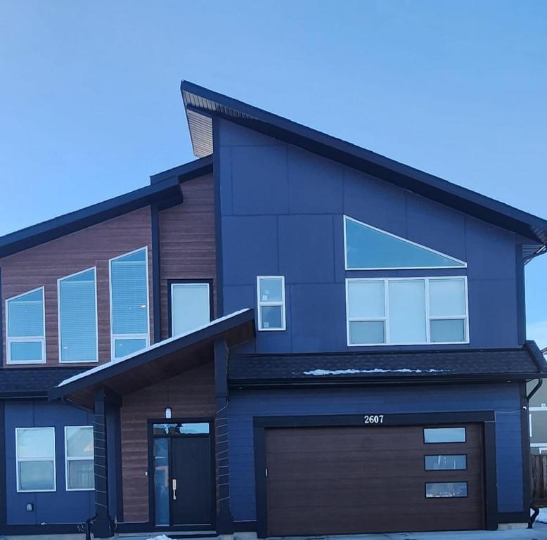 a house with a garage in front of it at Hebzibah's Luxe in Prince George