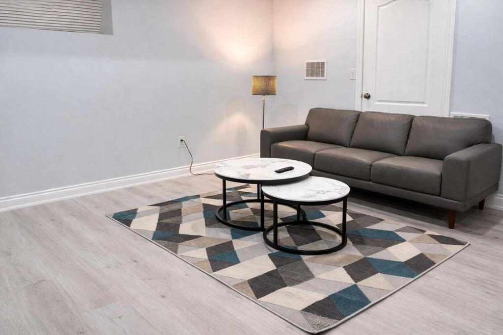 a living room with a couch and a table at Modern 2BR Basement Suite Private Entrance in Brampton