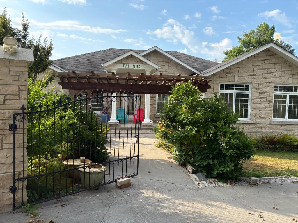 a house with a gate in front of a house at Lakeview in Colborne
