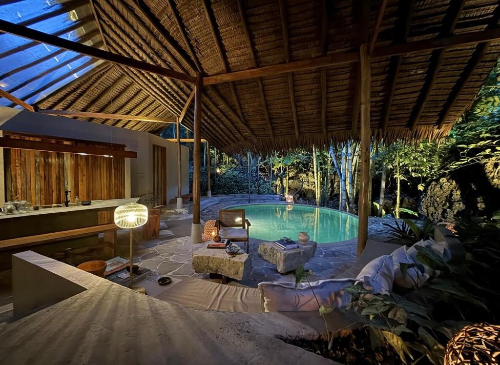 a swimming pool in a villa with a patio at Dalakit House Hidden Garden Oasis in Lambojon