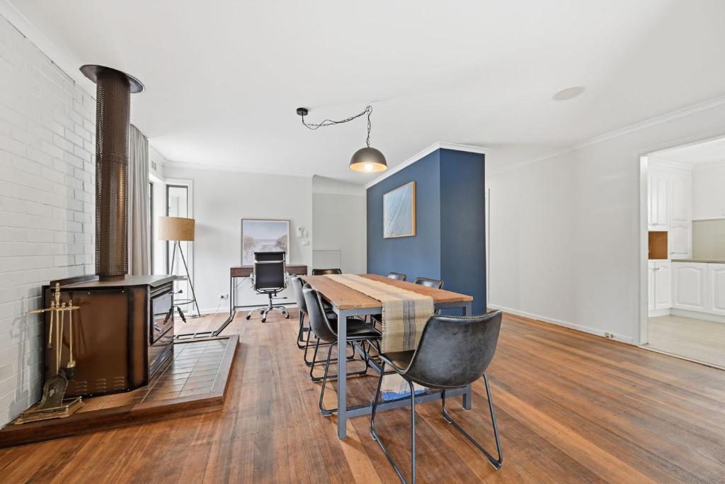 a living room with a table and chairs and a tv at Dixon Delight in Inverloch