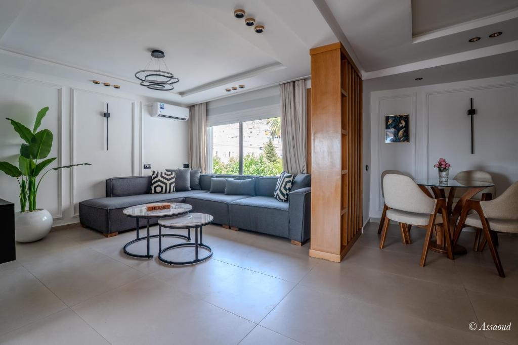 a living room with a blue couch and a table at RamoHouse bright home central in Chefchaouen