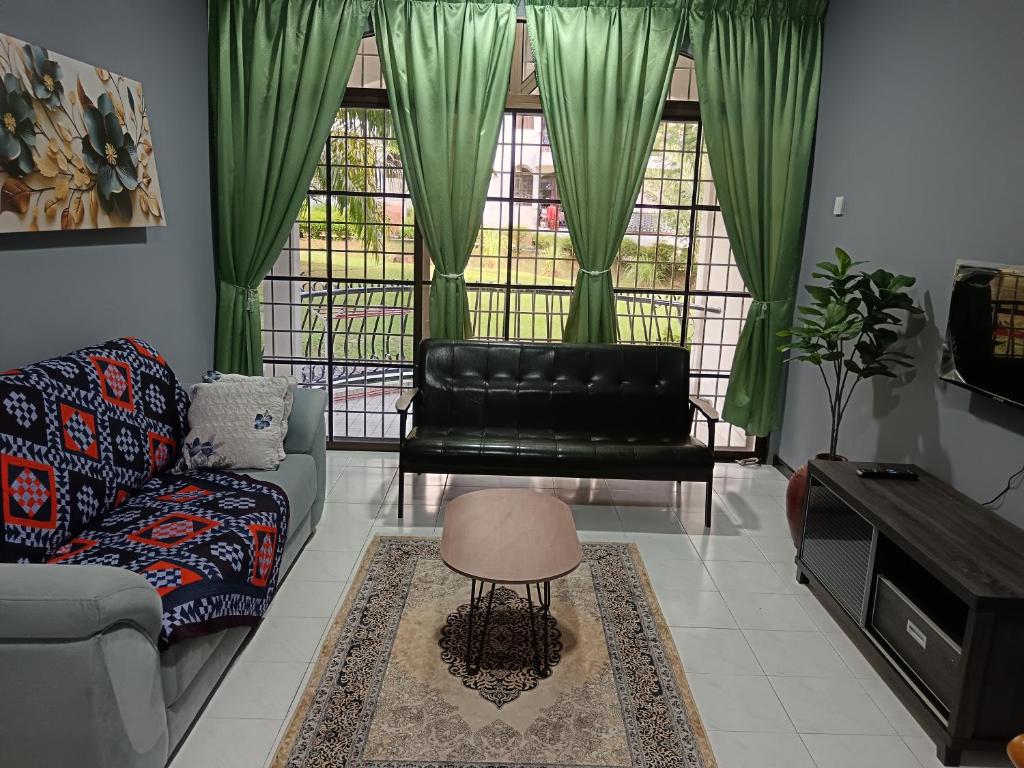 a living room with a couch and a table at ROSSA Condo 1 in Kuah