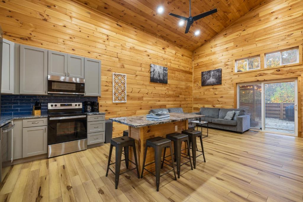 a kitchen and living room in a log cabin at New listing-- Hocking Hills Modern Cabin in Logan