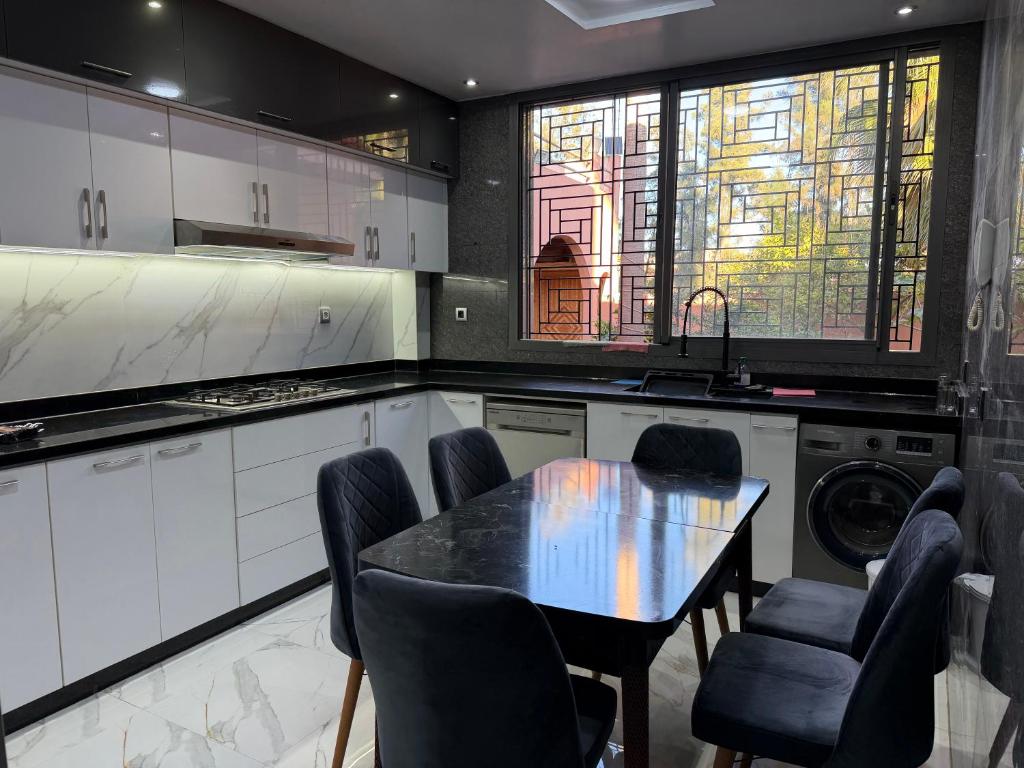 a kitchen with a table and chairs in it at Airport agadir villa in Agadir