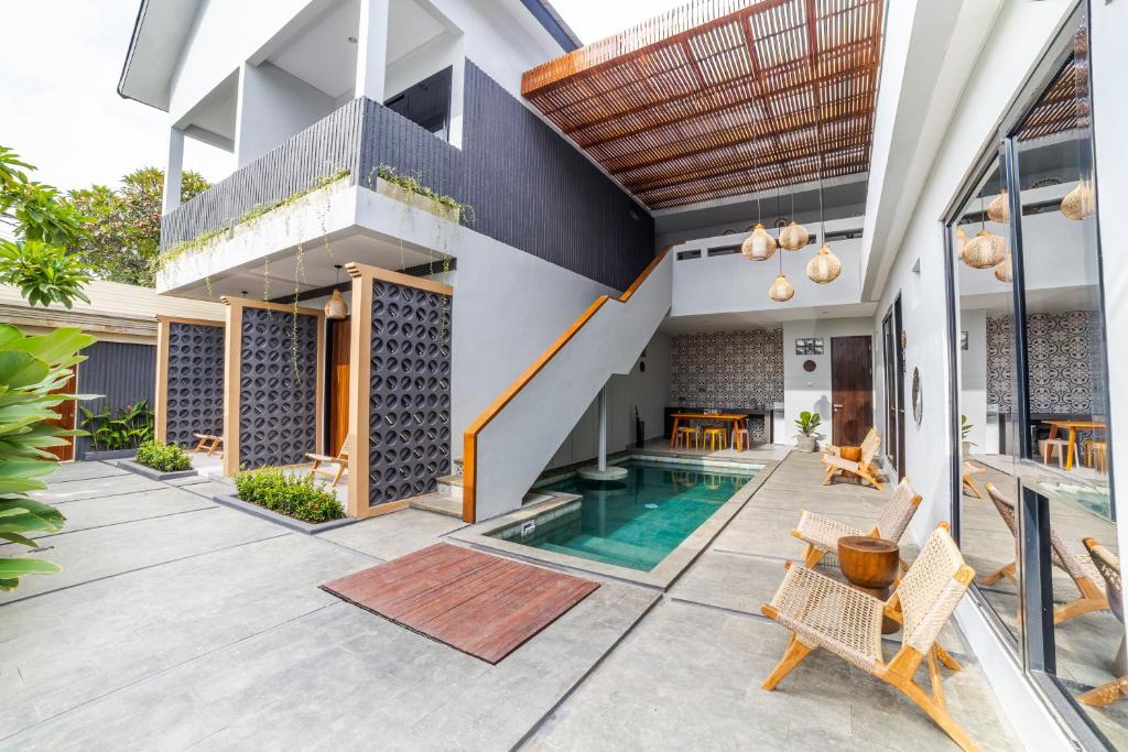 an external view of a house with a swimming pool at Padinis Villa & Coffee in Ketewel