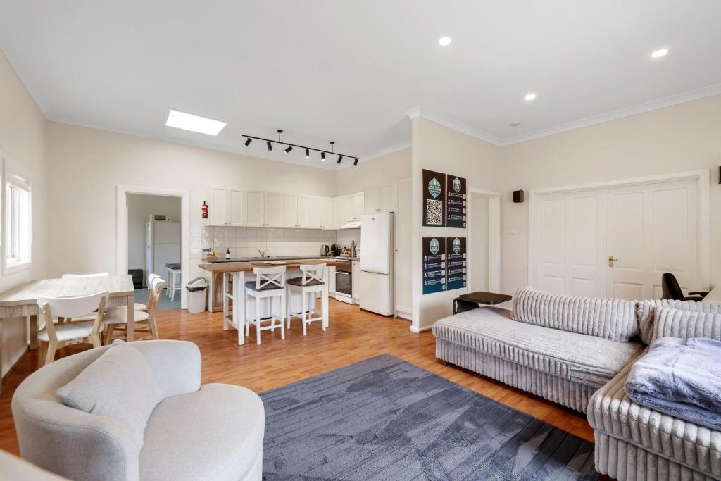 a living room with a couch and a table at Surf Beach Remote Retreat in Surf Beach