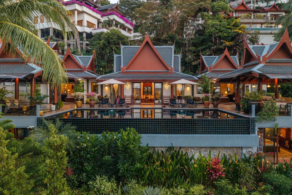 an image of a resort with a building at Arun Rapee Villa Surin Beach in Surin Beach