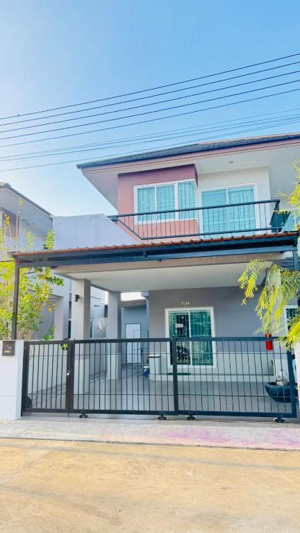 a house with a fence in front of it at Kitjamyhome2 in Ban Tha Thon