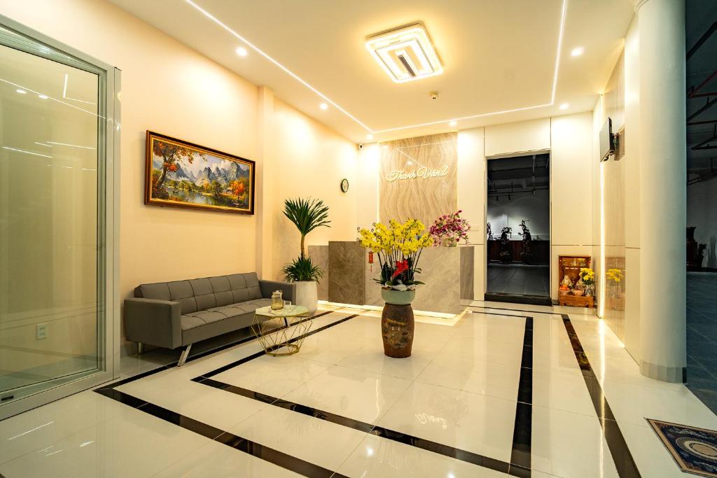 a living room with a couch and a vase of flowers at Hotel Thanh Van 2 in Tuy Hoa