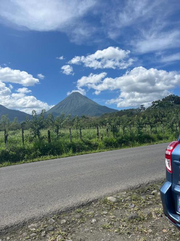 a car parked on the side of a road with a mountain at GuestHouse Detours CR in Fortuna