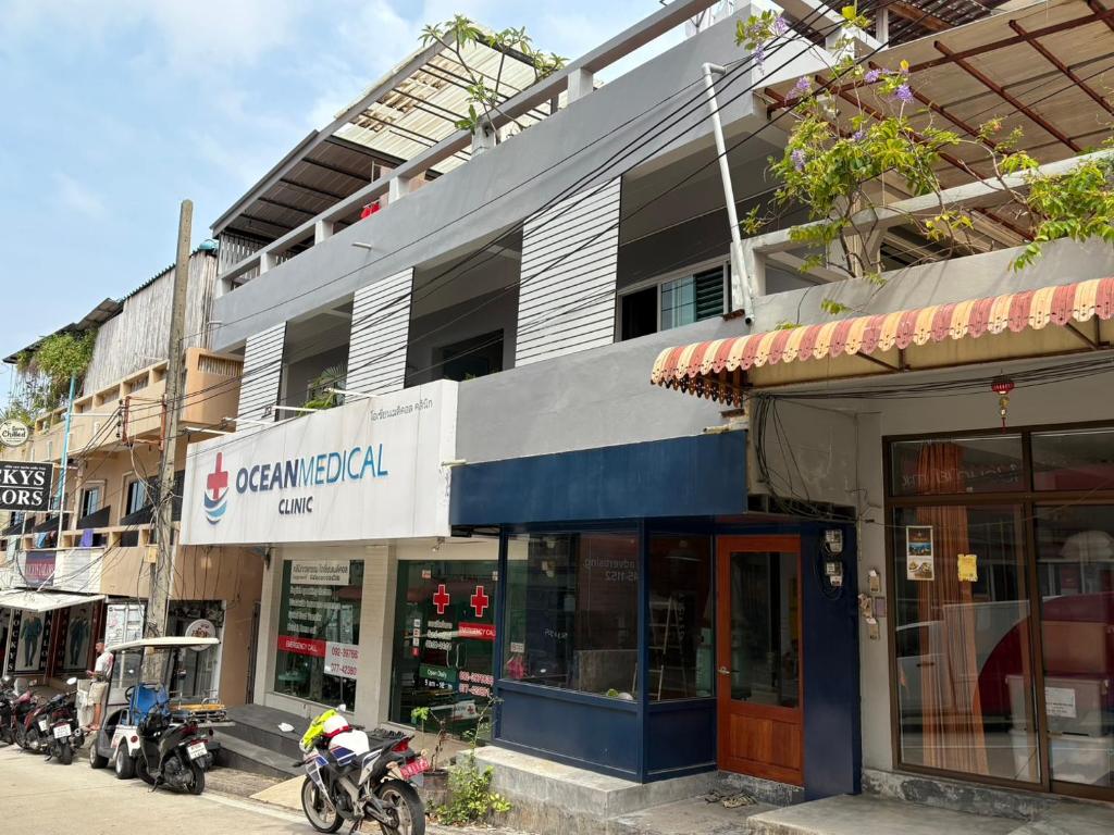 a group of motorcycles parked in front of a building at BW Guesthouse in Ko Tao