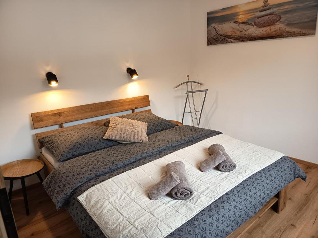 a bedroom with a bed with two towels on it at Apartmán U nás in Malá Morávka
