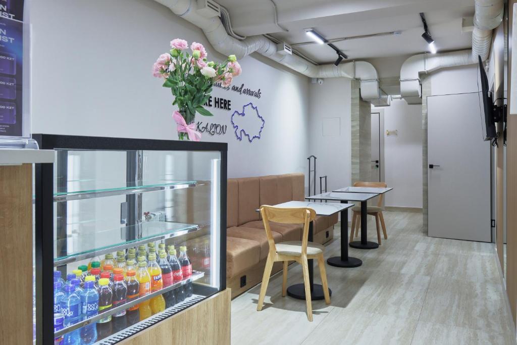 a waiting room with a table and drinks at Kalion Capsule and Boutique Hotel in Almaty