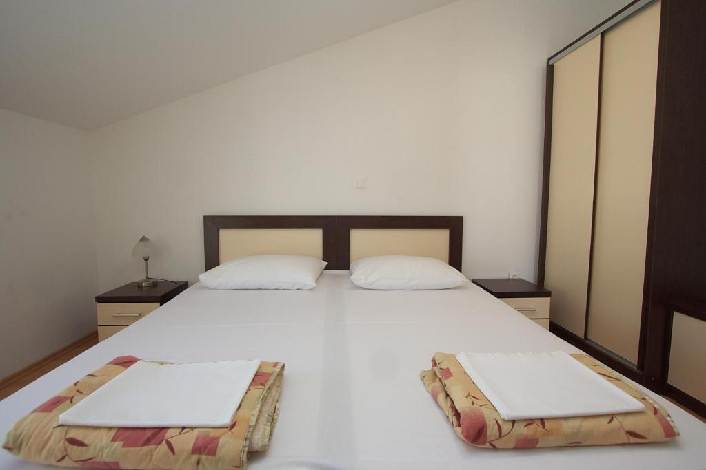 Łóżko lub łóżka w pokoju w obiekcie Apartments Novalja