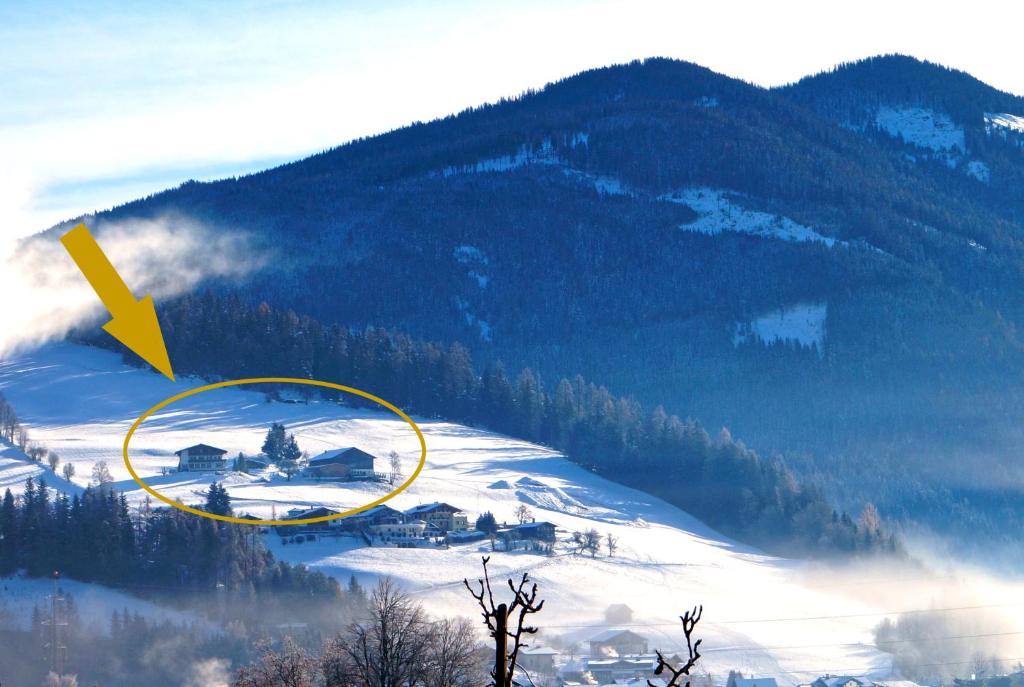a picture of a mountain with a house in the snow at Sauschneidhof - Radstadt in Radstadt