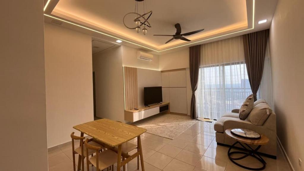 a living room with a couch and a table at HOMESTAY WITH 2 BEDROOMS IN NILAI for Malaysian traveler in Nilai