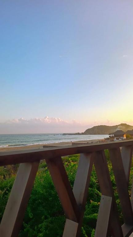 a bridge over a beach with the ocean in the background at Casa Laud Chacahua Isla in Guayabas
