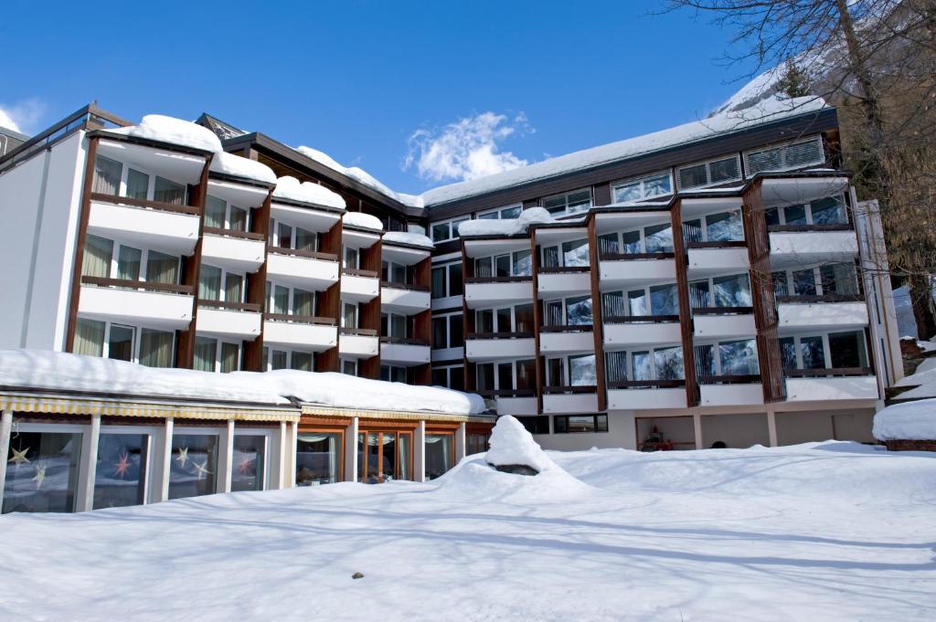 a large building with a ski lift on top of it at Hotel Quellenhof Leukerbad in Leukerbad