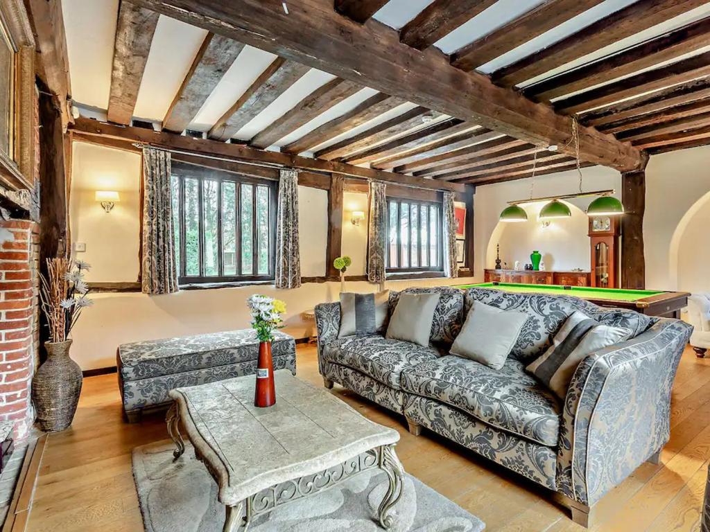 a living room with a couch and a table at The Farmhouse - Uk48228 in Tibenham