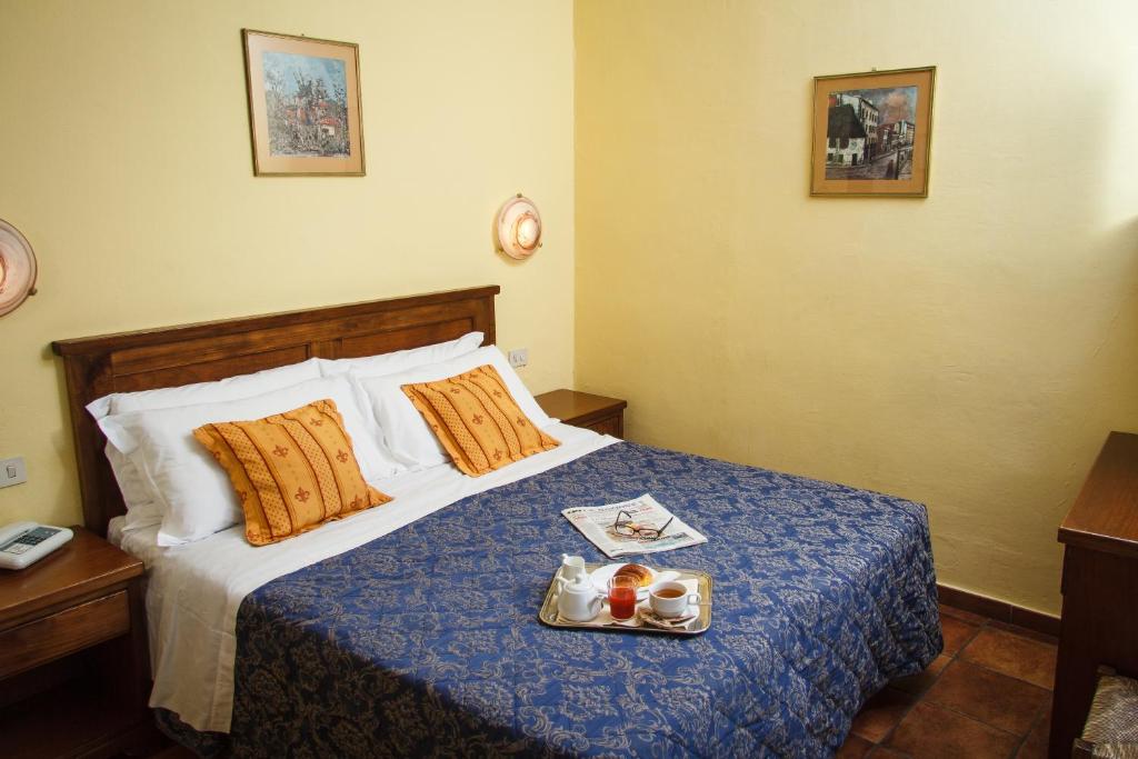 Postel nebo postele na pokoji v ubytování Hotel Nizza