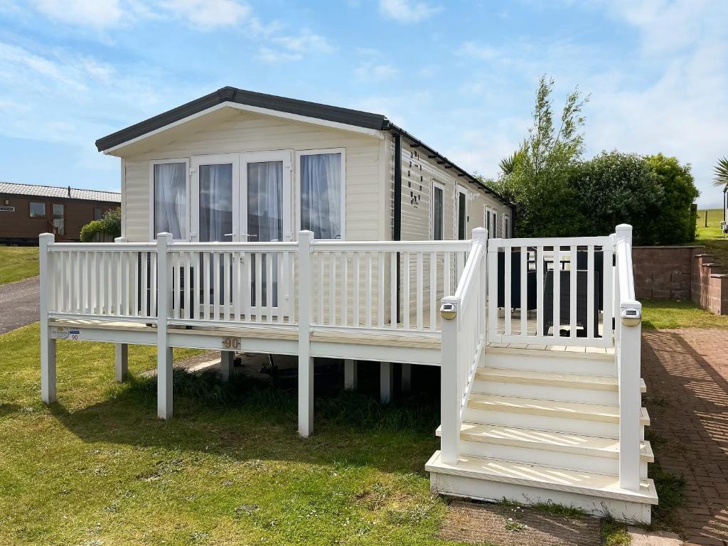 a white house with a porch and stairs at Sandy Paws - Uk45511 in Mainsriddle