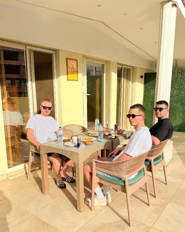 a group of men sitting at a table at Infinity Pyramids Inn in Giza