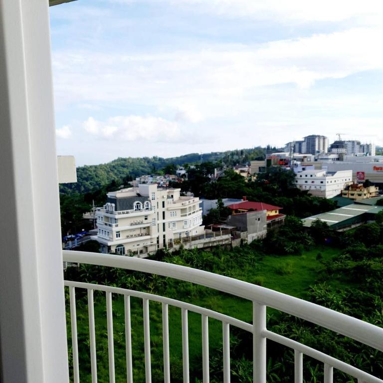 a balcony with a view of a city at Cozy Studio Condo with Stunning Tagaytay Views in Tagaytay