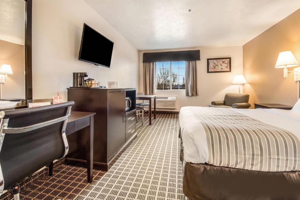 a hotel room with a bed and a desk at Econo Lodge Corvallis Near University in Corvallis