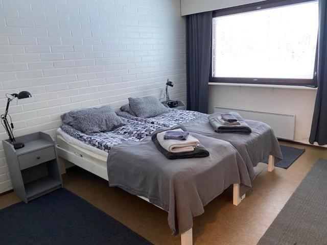 a bedroom with a bed with towels on it at Kangaskartano Yksiö in Keitelepohja