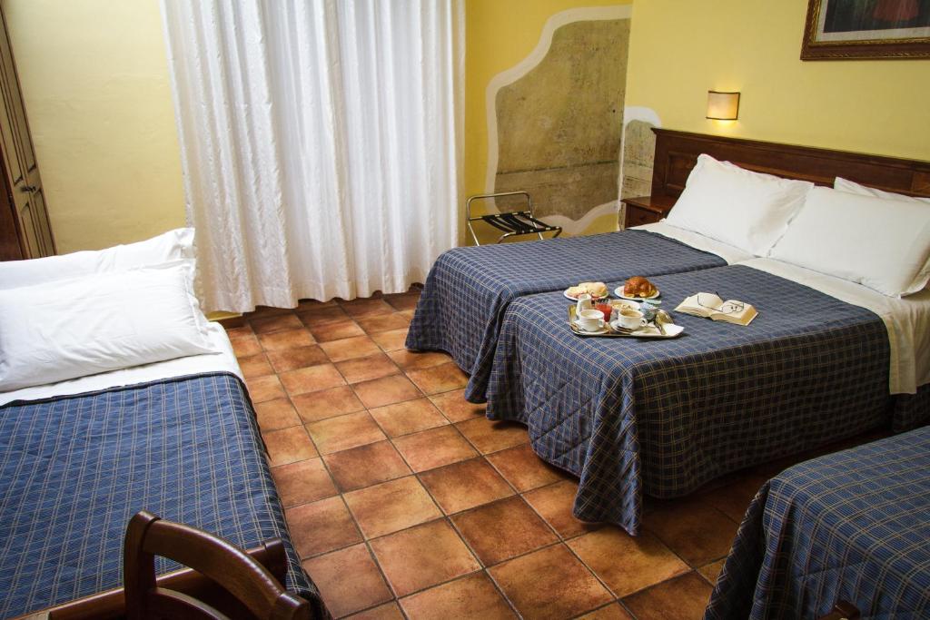 Postel nebo postele na pokoji v ubytování Hotel Nizza
