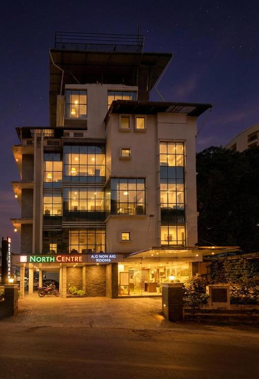 a large building with a sign in front of it at North Centre in Cochin