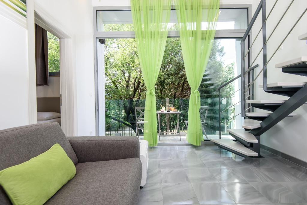 a living room with a couch and a large window at Apartments Mali Stradun in Dubrovnik